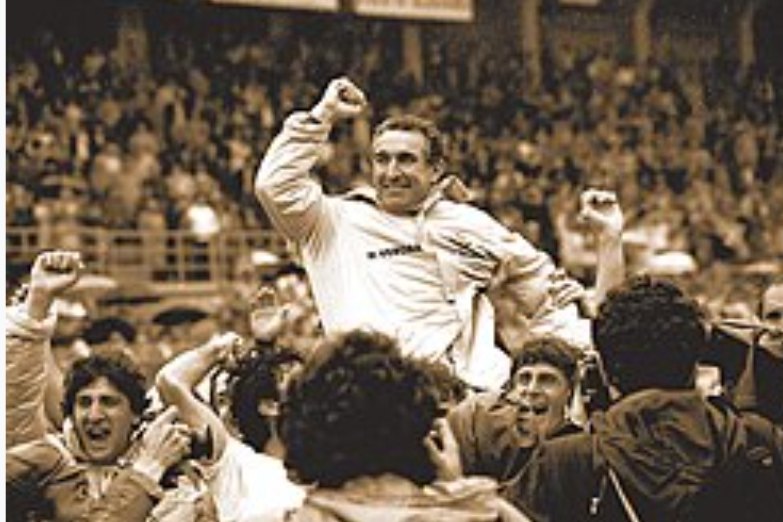 Osvaldo Bagnoli carried in triumph by his Hellas Verona players, fist raised, in a sepia-toned photograph